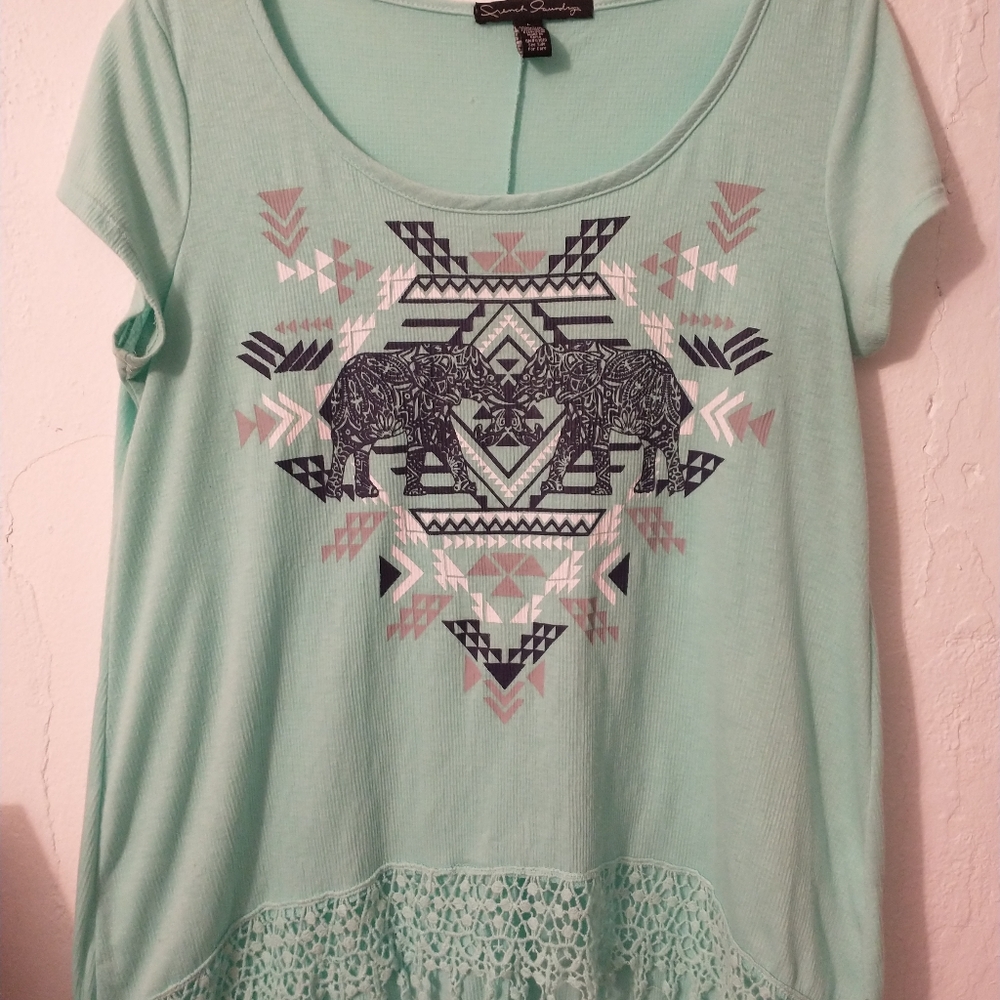 Mint green blouse with an elegant design and fringe.